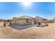 Back exterior view of house featuring desert landscaping, a covered patio, and modern architectural style at 11026 E Nopal Ave, Mesa, AZ 85209