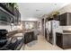 A spacious kitchen with stainless steel appliances, dark cabinets, and an open view to the dining area at 11026 E Nopal Ave, Mesa, AZ 85209