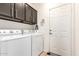 Functional laundry room featuring upper cabinets, washer, and dryer for efficient chore management at 11026 E Nopal Ave, Mesa, AZ 85209