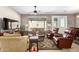 Well-lit living room featuring tile floors, a ceiling fan, and outdoor access at 11026 E Nopal Ave, Mesa, AZ 85209