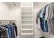 A well-organized walk-in closet with shelving and hanging rods for ample storage space at 11026 E Nopal Ave, Mesa, AZ 85209