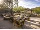 Beautiful patio with a fire pit and comfortable chairs, surrounded by lush landscaping and mountain views at 12322 E Black Rock Rd, Scottsdale, AZ 85255