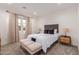 Stylish bedroom featuring neutral tones, plush carpet, and a cushioned bench, creating a serene and comfortable atmosphere at 13224 W Crimson Ter, Peoria, AZ 85383