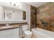 Cozy bathroom featuring a granite sink, a bathtub and a tiled wall at 13232 N 40Th Pl, Phoenix, AZ 85032