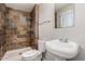 Bathroom featuring a tiled shower, modern sink, and large mirror at 13232 N 40Th Pl, Phoenix, AZ 85032