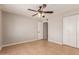 Neutral bedroom featuring tile floors, a ceiling fan, and a closet for ample storage space at 13232 N 40Th Pl, Phoenix, AZ 85032