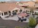 Aerial view of the backyard with outdoor kitchen, fire pit, and seating areas at 13583 S 177Th Ln, Goodyear, AZ 85338