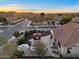 Stunning aerial view of backyard featuring patio with fire pit, outdoor kitchen, lounge chairs and desert landscaping at 13583 S 177Th Ln, Goodyear, AZ 85338