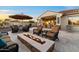 Inviting backyard patio with a cozy fire pit and comfortable seating, perfect for outdoor relaxation at 13583 S 177Th Ln, Goodyear, AZ 85338