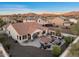 Wonderful backyard with stone patio, outdoor kitchen, seating around fire pit, and mountain views at 13583 S 177Th Ln, Goodyear, AZ 85338