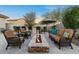 Relaxing backyard featuring a modern fire pit, outdoor bar with stools, and comfortable lounge seating at 13583 S 177Th Ln, Goodyear, AZ 85338