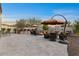 Expansive backyard with a full outdoor kitchen, fire pit, and multiple seating areas at 13583 S 177Th Ln, Goodyear, AZ 85338