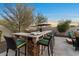 Outdoor kitchen and bar area in the backyard, perfect for entertaining, with outdoor seating at 13583 S 177Th Ln, Goodyear, AZ 85338