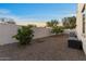 Low-maintenance backyard with desert landscaping and privacy wall at 13583 S 177Th Ln, Goodyear, AZ 85338