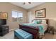 Inviting bedroom with a bright window, dark wood furniture, and a colorful quilt for a cozy retreat at 13583 S 177Th Ln, Goodyear, AZ 85338