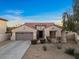 Single-story house featuring desert landscaping, two car garage, and a welcoming front entrance at 13583 S 177Th Ln, Goodyear, AZ 85338