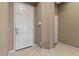 Welcoming foyer with tile flooring leading to a white door at 13583 S 177Th Ln, Goodyear, AZ 85338