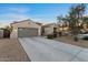 Charming single-story home with a desert-landscaped front yard and a spacious driveway leading to the garage at 13583 S 177Th Ln, Goodyear, AZ 85338