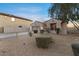 Attractive home with desert landscaping and a two-car garage, framed by mature trees and shrubs at 13583 S 177Th Ln, Goodyear, AZ 85338