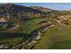 An attractive aerial view of a green and beautifully maintained golf course nestled in a picturesque desert landscape at 13583 S 177Th Ln, Goodyear, AZ 85338