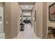 Bright hallway with neutral walls, tile flooring, and a glimpse into a comfortable living area at 13583 S 177Th Ln, Goodyear, AZ 85338