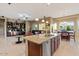 Open-concept kitchen with granite countertops, stainless steel appliances, and seamless flow to living area at 13583 S 177Th Ln, Goodyear, AZ 85338