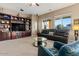 Comfortable living room featuring built-in shelving, neutral colors and large windows at 13583 S 177Th Ln, Goodyear, AZ 85338