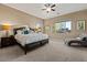 Comfortable main bedroom featuring soft carpet, neutral walls, and large windows for lots of natural light at 13583 S 177Th Ln, Goodyear, AZ 85338