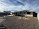 Backyard with gravel, desert landscaping, and a house equipped with solar panels at 13846 N Tan Tara Dr, Sun City, AZ 85351