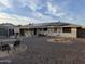 Backyard with gravel, desert landscaping, solar panels and a covered patio at 13846 N Tan Tara Dr, Sun City, AZ 85351