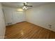 Bedroom features wood-look flooring, ceiling fan, and closet at 13846 N Tan Tara Dr, Sun City, AZ 85351