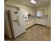 Bright kitchen with white appliances and ample cabinet space, ready for culinary adventures and Gathering meals at 13846 N Tan Tara Dr, Sun City, AZ 85351