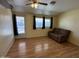 Living room features hardwood-look flooring, sofa, windows, and back door at 13846 N Tan Tara Dr, Sun City, AZ 85351