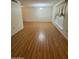 Inviting living room boasting sleek wood flooring and natural light, creating a warm and comfortable space at 13846 N Tan Tara Dr, Sun City, AZ 85351