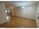 Inviting living room boasting sleek wood flooring and natural light, creating a warm and comfortable space at 13846 N Tan Tara Dr, Sun City, AZ 85351