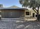 Backyard view of a screened-in patio with a unique, decorative brick base and desert landscaping around the house at 13914 W Terra Vista Dr, Sun City West, AZ 85375