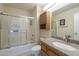 Bathroom with a shower-tub combination, granite countertop, wood cabinet, and framed mirror at 13914 W Terra Vista Dr, Sun City West, AZ 85375