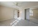 Bedroom featuring neutral walls, carpeted floor, mirrored closet doors, and a ceiling fan with lighting at 13914 W Terra Vista Dr, Sun City West, AZ 85375