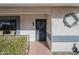 Inviting front entrance with security door, decorative wreath, and meticulously maintained desert rock landscaping at 13914 W Terra Vista Dr, Sun City West, AZ 85375