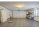 View of a spacious two car garage, complete with ample lighting, shelving, and storage for the homeowner at 13914 W Terra Vista Dr, Sun City West, AZ 85375