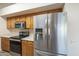 Functional kitchen featuring wood cabinets, stainless steel appliances, and ample counter space at 13914 W Terra Vista Dr, Sun City West, AZ 85375