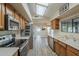 Bright kitchen with stainless steel appliances, wood cabinets, and a skylight providing natural light at 13914 W Terra Vista Dr, Sun City West, AZ 85375