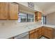 Bright kitchen featuring oak cabinets, bright countertops, and stainless steel appliances at 13914 W Terra Vista Dr, Sun City West, AZ 85375