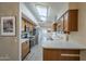 Galley kitchen featuring a skylight, stainless steel appliances, and oak cabinets at 13914 W Terra Vista Dr, Sun City West, AZ 85375