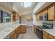 Open kitchen featuring wood cabinets, stainless steel appliances, and a view of the dining area at 13914 W Terra Vista Dr, Sun City West, AZ 85375