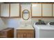 Laundry room with white front loading machines and cabinets at 13914 W Terra Vista Dr, Sun City West, AZ 85375