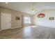 Spacious living room with wood-look floors, a large window and a bright neutral palette at 13914 W Terra Vista Dr, Sun City West, AZ 85375