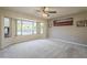 Living room featuring large windows providing ample natural light, neutral carpet, and neutral paint at 13914 W Terra Vista Dr, Sun City West, AZ 85375