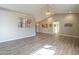 Bright and airy living room with vaulted ceilings and wood-look floors flowing into the kitchen at 13914 W Terra Vista Dr, Sun City West, AZ 85375