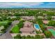 Aerial shot of the property with large backyard pool, tennis court, and lush green landscaping at 1440 N 40Th St # 4, Mesa, AZ 85205